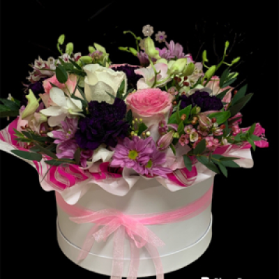 Stylish Spring - A stunning mixed hat box arrangement filled with assorted blooms, that may include orchids, carnations, roses, alstroemerias , lizzies, spray roses etc, some flowers may vary depending on availability or a similar substitute will be used, hat box colours may vary depending on availability 
