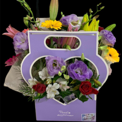 Rainbow of Love - A beautiful heart shaped box brimming with a rainbow of colours assorted flowers Lillys, Gerberas , Roses, Carnations , Orchids, Etc